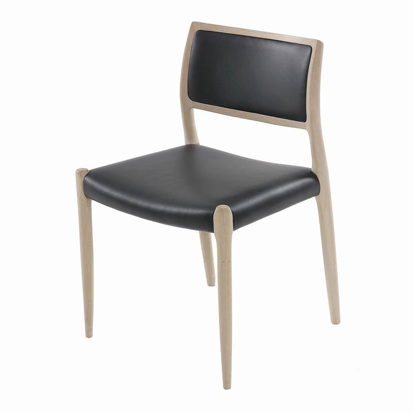 Modern chair with a sleek black leather seat and natural wood frame, featuring minimalistic design and clean lines.