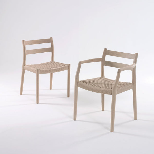 Light beige chairs with woven seat patterns and minimalist design. Elegant and modern style for any decor.