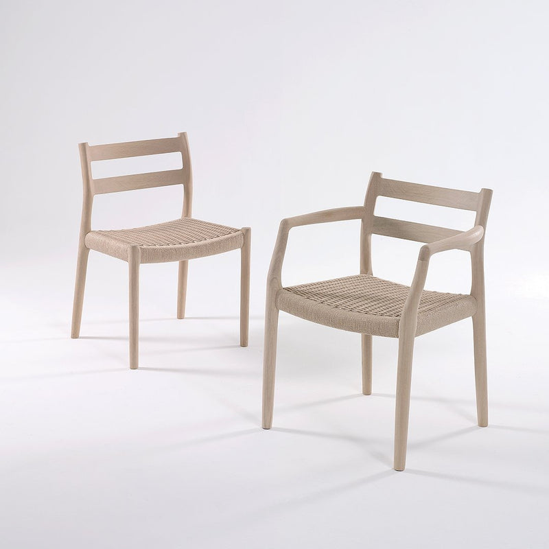 Light beige chairs with woven seat patterns and minimalist design. Elegant and modern style for any decor.
