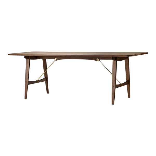 Walnut wood dining table with a sleek, smooth surface and minimalistic golden accents. Elegant and modern design.