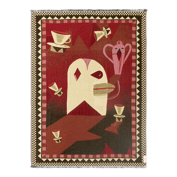 Bold red tapestry featuring geometric patterns and stylized bird designs with cream and black accents.