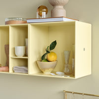Light yellow shelving unit with natural decor, featuring white and clear glass accents, and geometric patterns.
