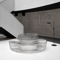 Stylish transparent coffee table with a modern circular design, featuring sleek lines and a minimalist aesthetic.