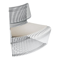 Modern silver wire chair with a sleek, minimalist design and a light beige cushion. Elegant curves and contemporary style.