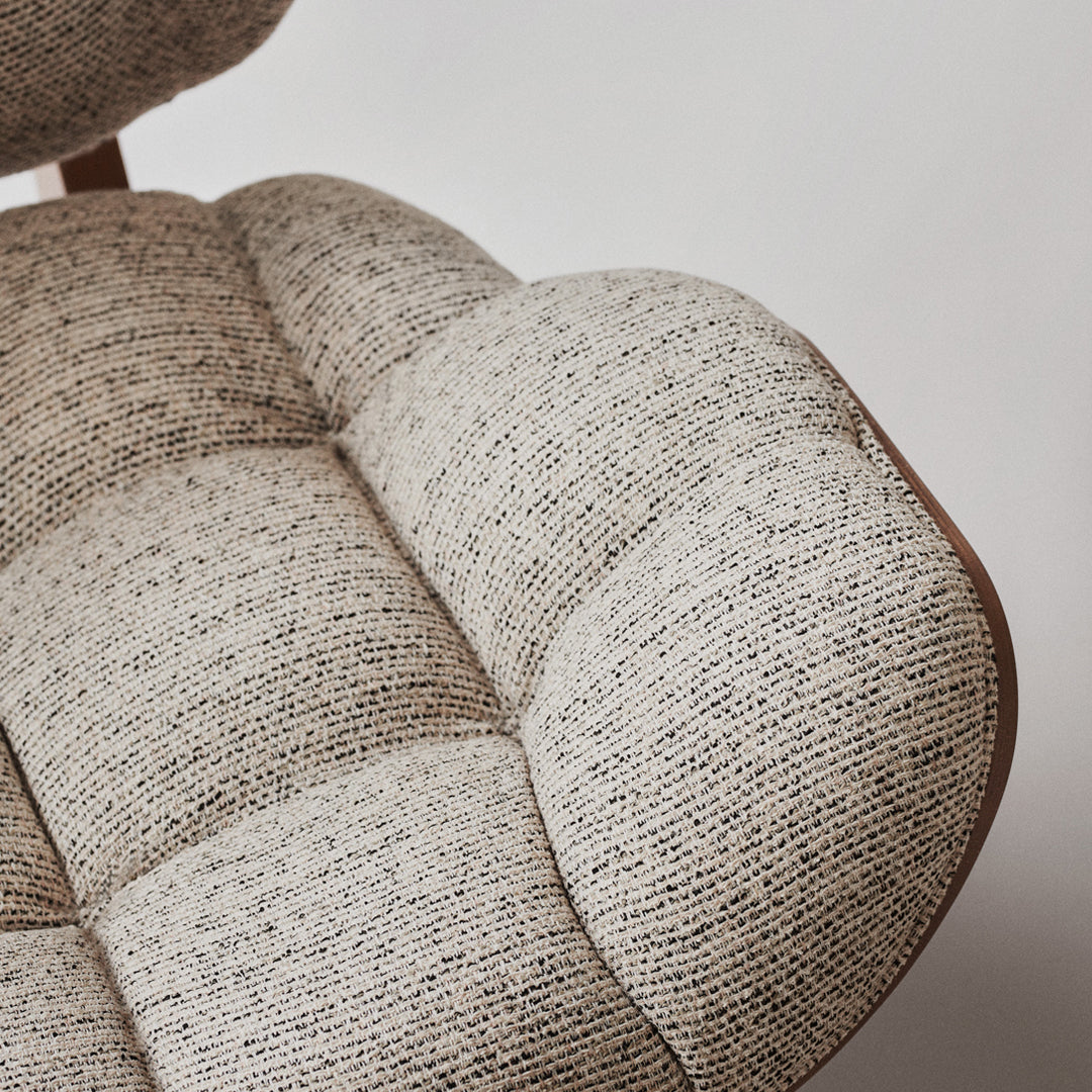 Beige and gray textured upholstery with a tufted pattern, showcasing modern design elegance.