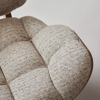 Beige and gray textured upholstery with a tufted pattern, showcasing modern design elegance.
