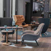 Stylish chairs in gray and orange, with smooth curves and modern patterns, set on light wooden floors.