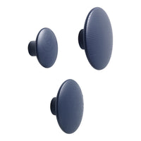 Set of three round navy blue wall hooks with textured surface patterns, varying sizes for versatile styling.