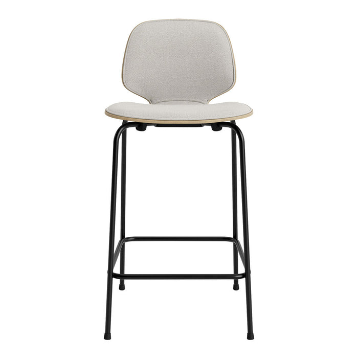 Modern bar stool featuring a textured light gray seat and natural wood accents on a sleek black metal frame.