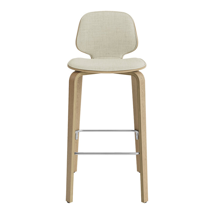 Beige upholstered high stool with light wood legs and a sleek silver footrest, featuring a minimalist design.