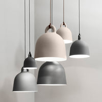 Modern pendant lights in soft gray and beige tones, featuring sleek matte finishes and elegant bell shapes.