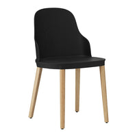 Black chair with a smooth finish and natural wood legs, perfect for modern decor. Minimalist and stylish design.