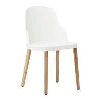 White minimalist chair with smooth curves and natural wood legs, perfect for modern interiors.