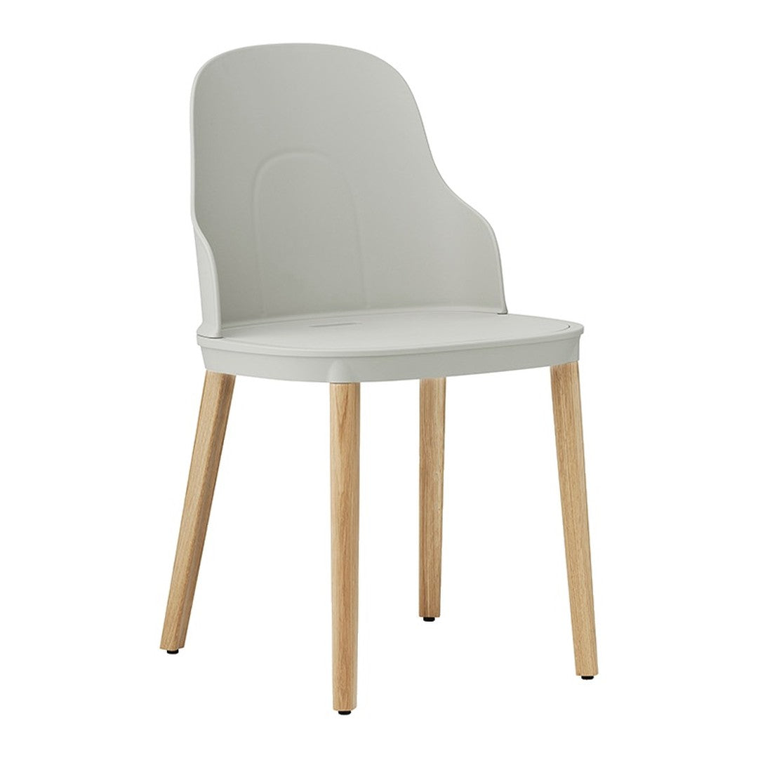 Light gray plastic chair with natural wood legs, featuring a sleek, minimalist design and smooth contours.