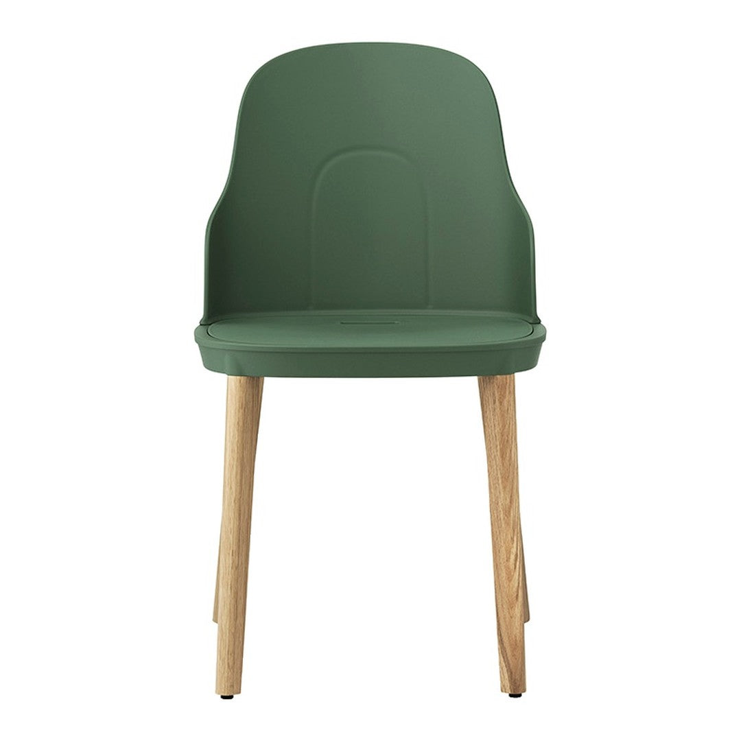 Green molded chair with natural wooden legs, featuring a sleek and minimalist design. Ideal for modern decor.