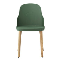 Green molded chair with natural wooden legs, featuring a sleek and minimalist design. Ideal for modern decor.
