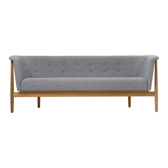 Gray upholstered sofa with button detailing and wooden legs, showcasing a modern, minimalist design.