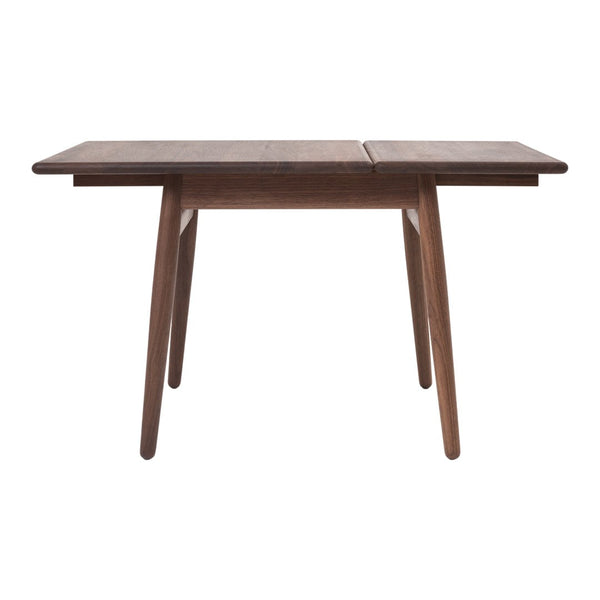 Brown wooden dining table with a sleek, minimalist design and natural wood grain pattern. Perfect for modern decor.