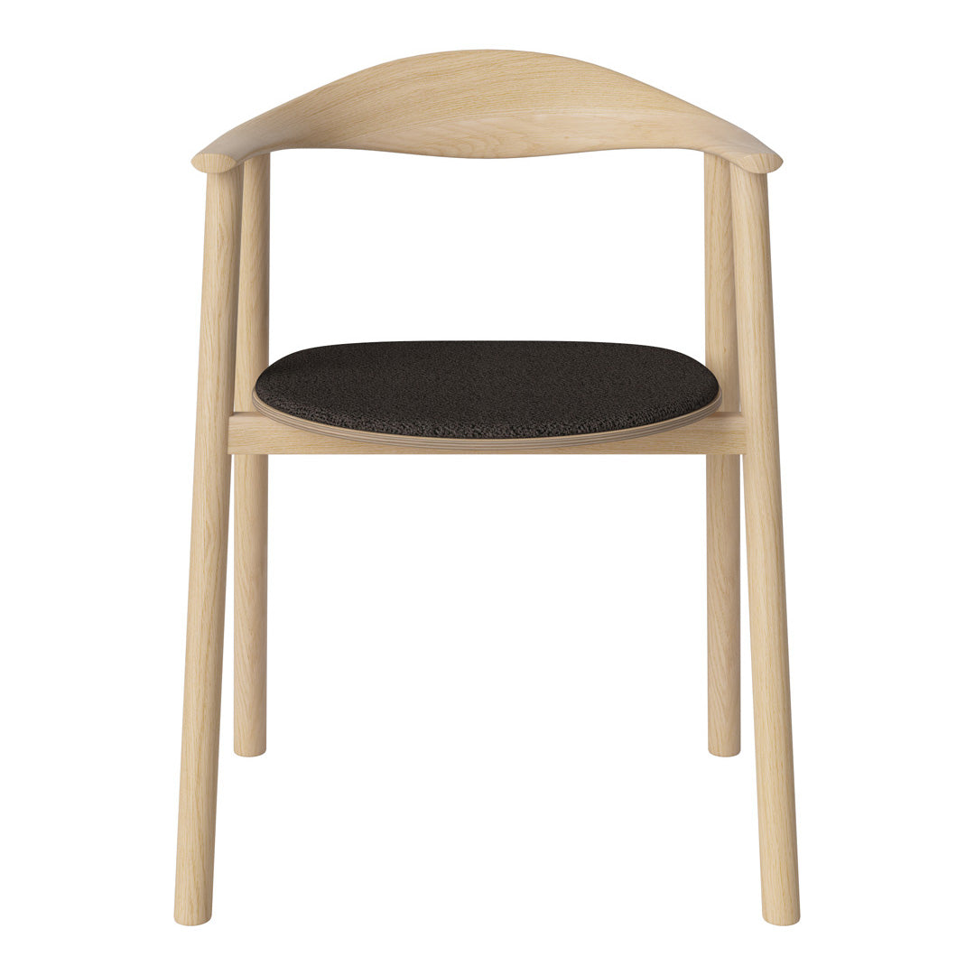 Light wood chair with a smooth, curved backrest and a dark black upholstered seat. Simple, modern design.