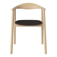 Light wood chair with a smooth, curved backrest and a dark black upholstered seat. Simple, modern design.