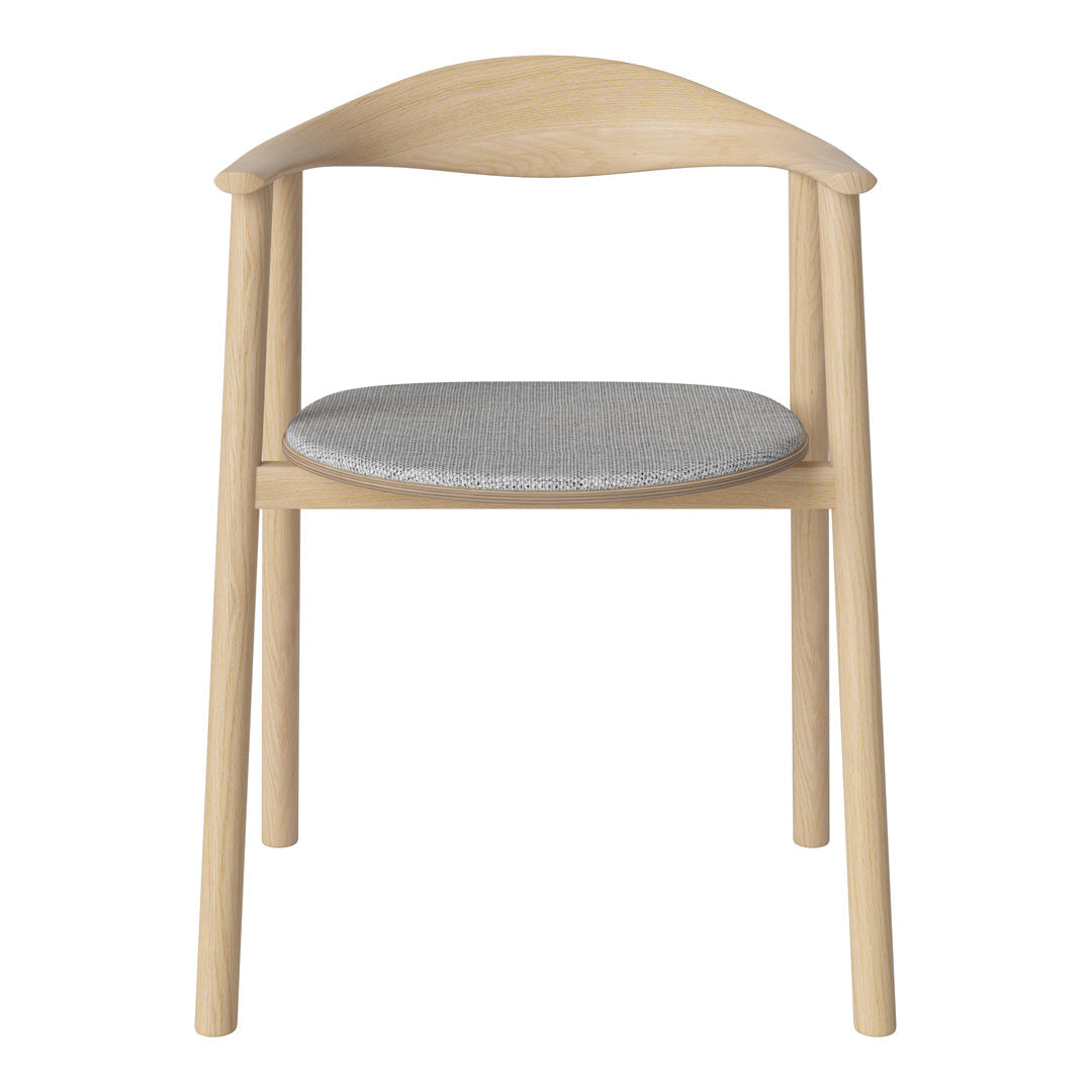 Light wood chair with a smooth, curved back and a soft gray upholstered seat. Modern and minimalist design.