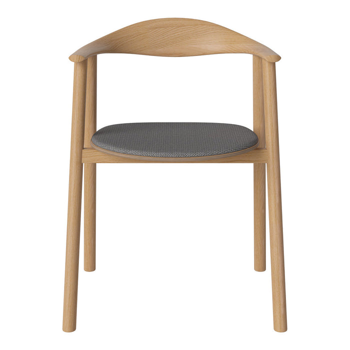 Light wood chair with a curved back and a gray upholstered seat, showcasing a minimalist design and neutral color palette.