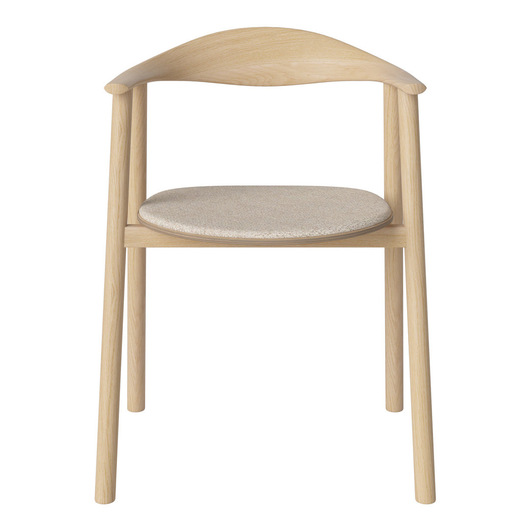 Light wood chair with curved backrest and soft beige fabric seat, showcasing a minimalist design.