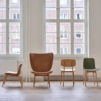 Stylish chairs in brown leather, natural wood, and green finish showcase modern design and minimalistic patterns.