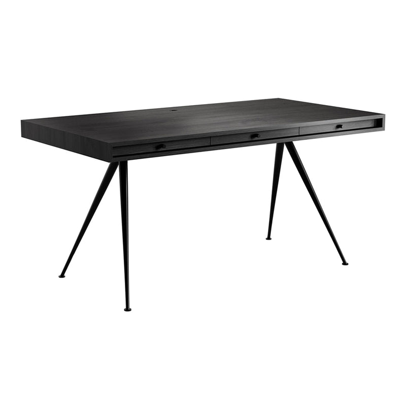 Sleek black desk with a smooth surface and angular black metal legs, featuring a minimalist design.