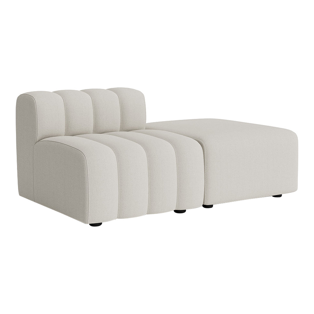 Modern cream sectional sofa featuring soft, rounded lines and subtle vertical ribbed patterns. Perfect for minimalistic decor.