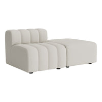 Modern cream sectional sofa featuring soft, rounded lines and subtle vertical ribbed patterns. Perfect for minimalistic decor.