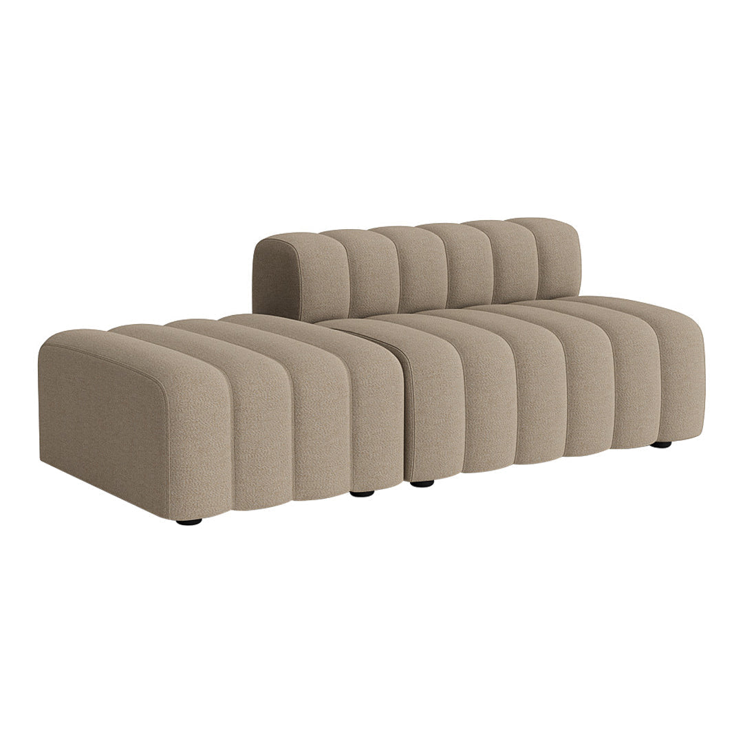 Beige upholstered sofa with a modern ribbed design, featuring soft, curved lines and a contemporary aesthetic.