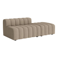 Beige upholstered sectional sofa with ribbed design and smooth curvy lines. Perfect for modern living spaces.