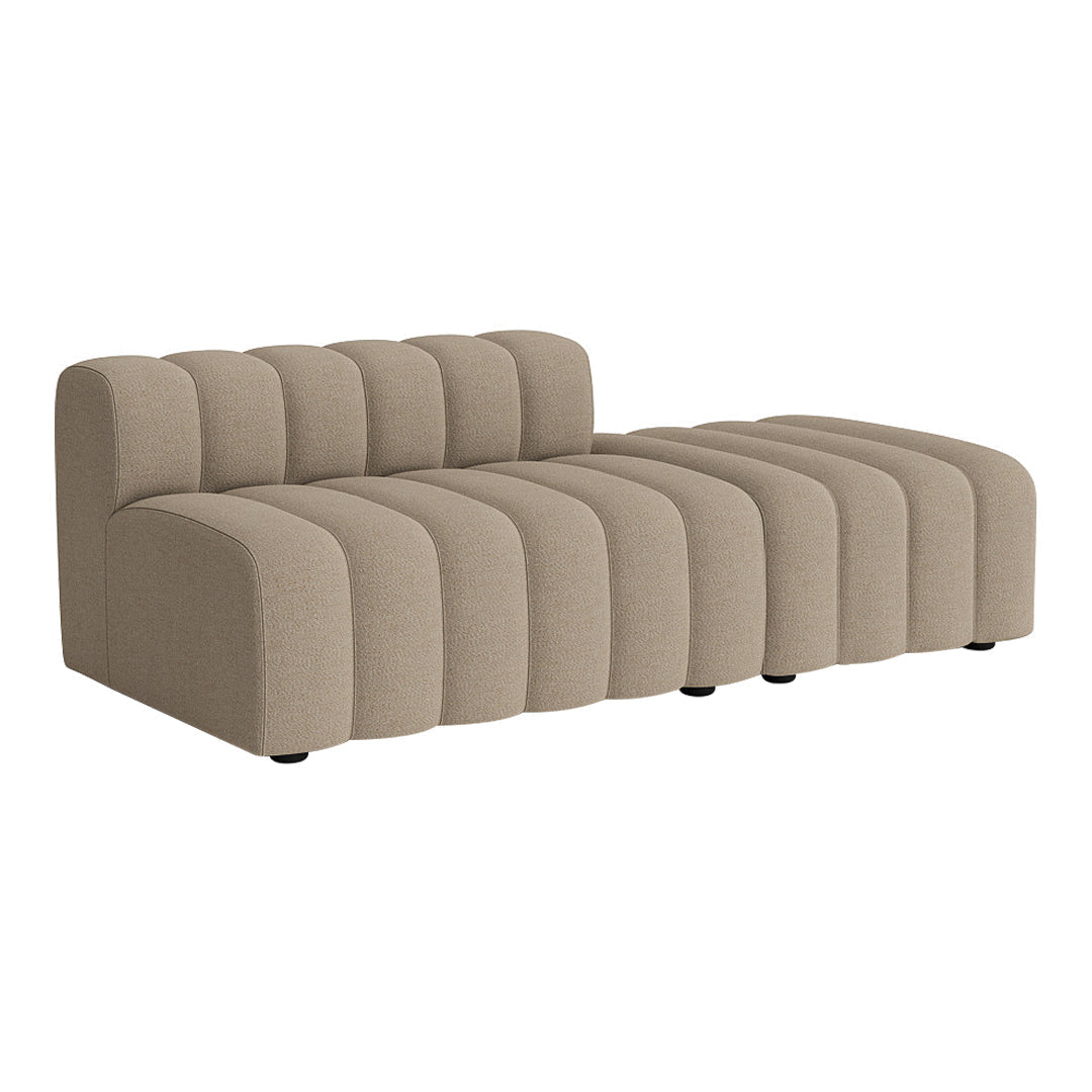 Beige upholstered sectional sofa with ribbed design and smooth curvy lines. Perfect for modern living spaces.