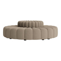Circular tufted ottoman in soft beige fabric with a ribbed pattern, adding texture and warmth to any space.