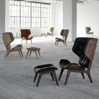 Stylish mid-century chairs in brown and black upholstery with sleek wooden legs, ideal for modern decor.