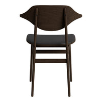 Dark wooden chair with a smooth black seat and a unique, curved back design, showcasing a minimalist aesthetic.
