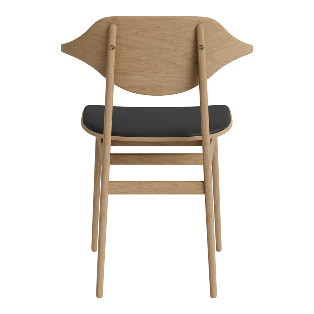 Light oak wood chair with a curved backrest and a sleek black seat, showcasing a modern minimalist design.