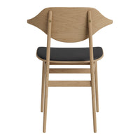 Light oak wood chair with a curved backrest and a sleek black seat, showcasing a modern minimalist design.