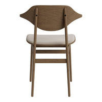 "Light wood chair with curved backrest and cream-colored seat cushion, minimalistic design."
