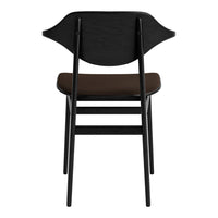 Black chair with a smooth brown seat and a unique curved backrest design.