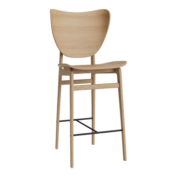 Light wood bar stool with a minimalist design, featuring a smooth, curved back and simple black metal footrest.