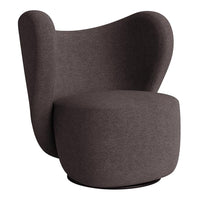 Modern dark brown accent chair with a smooth, sculptural design and soft fabric texture. Ideal for contemporary decor.