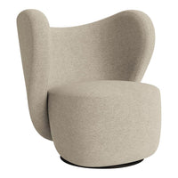 "Beige upholstered chair with a smooth, curved silhouette and minimalistic design."
