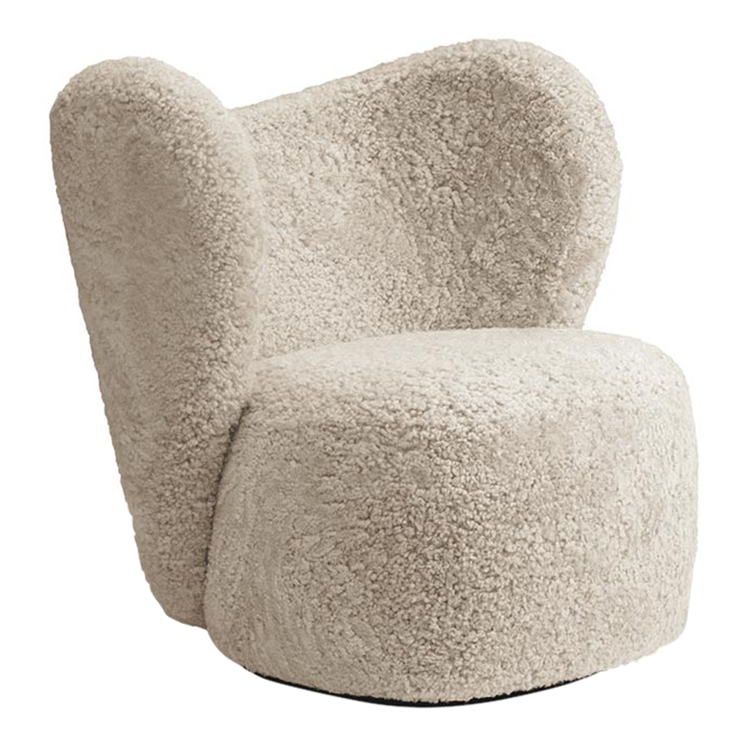 Soft beige accent chair with a textured, fluffy pattern, featuring rounded, modern design elements.