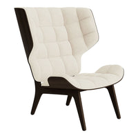 Cream and dark brown upholstered chair with a tufted pattern and sleek, modern design.
