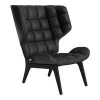 Black tufted armchair with a sleek design and distinctive high backrest for a modern touch.