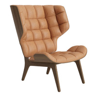 Tan tufted leather chair with a modern design and angular wooden legs. Perfect for contemporary interiors.
