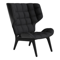 Black upholstered chair with a quilted pattern and sleek wooden legs, showcasing modern design and elegance.