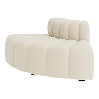 Beige curved couch with tufted design and smooth upholstery, ideal for modern interiors.
